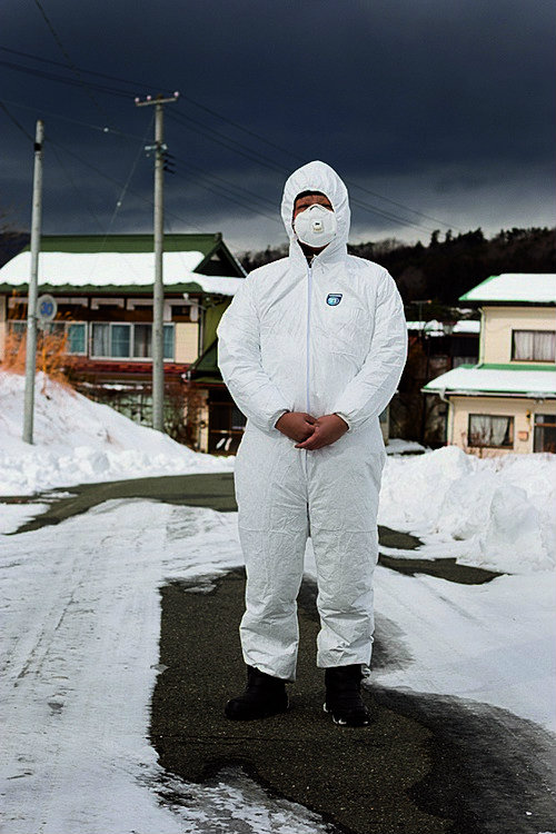 Ryuko Ishikawa (39 yrs old), a Buddhist priest whose temple Kannon-ji is situated in Namie town within the Fukushima nuclear exclusion zone, photographed wearing protective clothing in the highly radiated and now evacuated and deserted Iitate village, jus