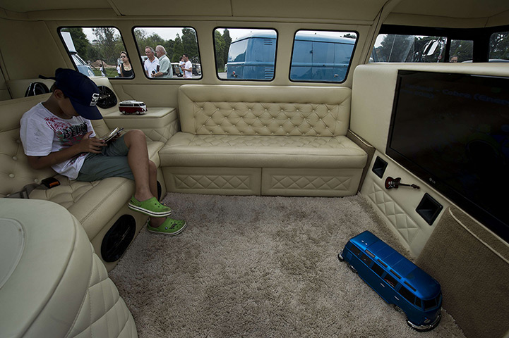 A boy plays with a tablet inside a Kombi