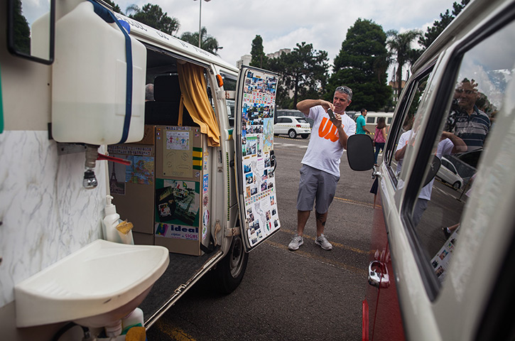 A man takes a photograph of the inside of a van