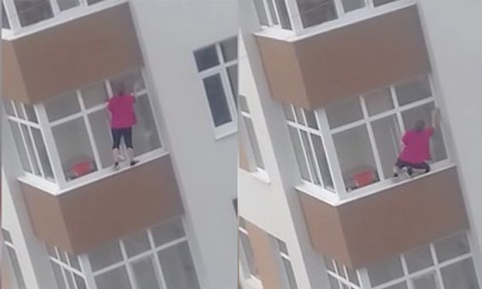 หวาดเสียว หญิงปีนตึกชั้น 5 เช็ดกระจกแบบไร้ลวดสลิง