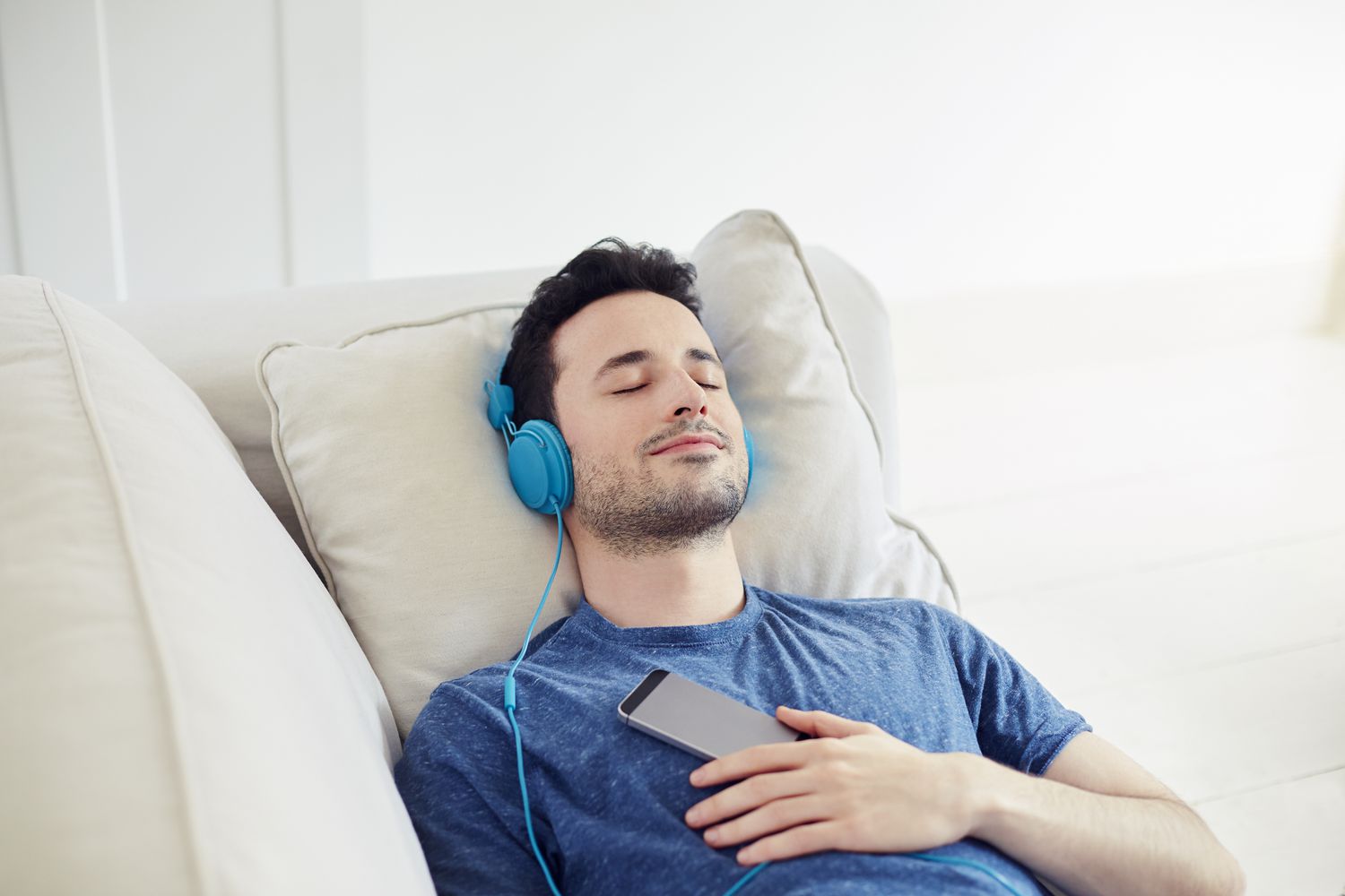 guy-with-headphones-on-relaxe