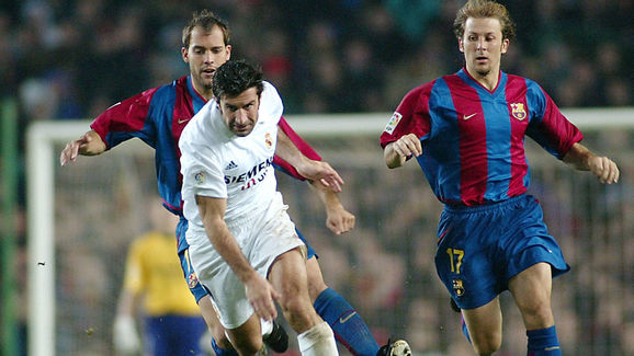 Portuguese Real Madrid's Luis Figo (C) vies betwen