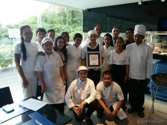 Blue Mango Patong Staff showing off the official Travellers' Choice Winner Plaque