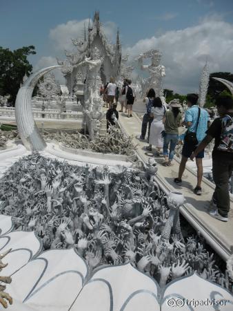 Ghoulish faces and menacing hands warning of life's temptations at the entrance