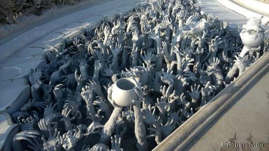 The bridge of the cycle of rebirth has hundreds of outreached hands symbolizing unrestrained des