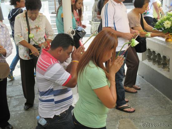 Local citizens praying with lotus flower