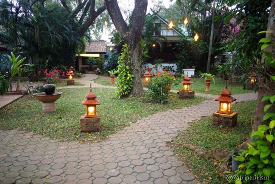 Well landscaped grounds are filled with sculptures and flowers.