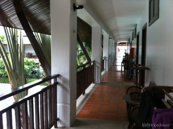Outdoor entry to rooms with teak chairs, drying racks, and, in the evening lovely incense pots.