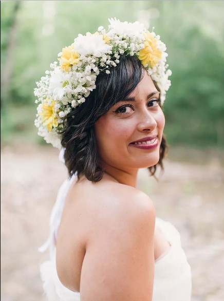 Short wedding hairstyle with a white and yellow flower crown