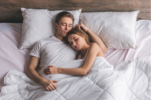 1531237785 couple asleep cuddling in bed