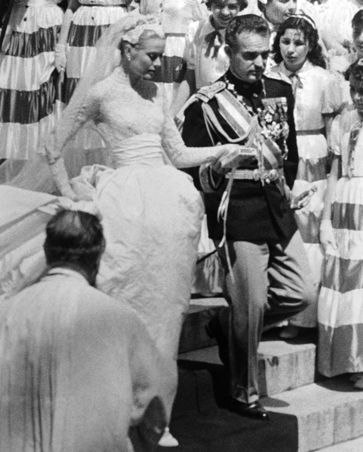 Prince Rainier leads his bride, Grace Kelly, after their wedding at Monaco Cathedral on April 19, 1956